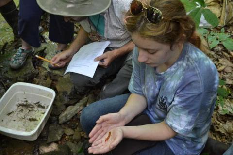 student with bug in hand